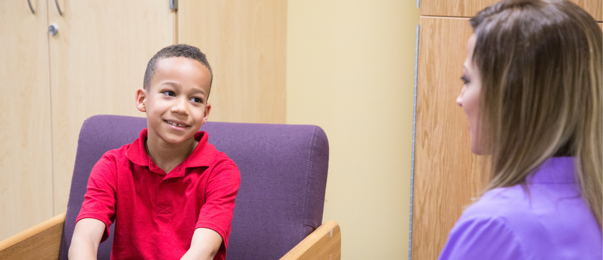Young African American Boy talking to a Doctor at an Appointment